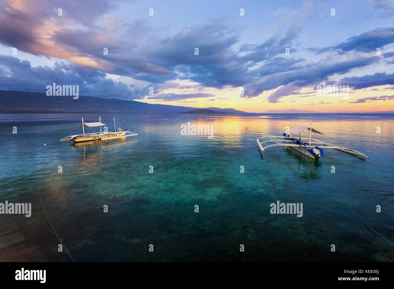 Sunset Over The Ocean With Pump Boats; Moalboal, Cebu, Central Visayas, Philippines Stock Photo