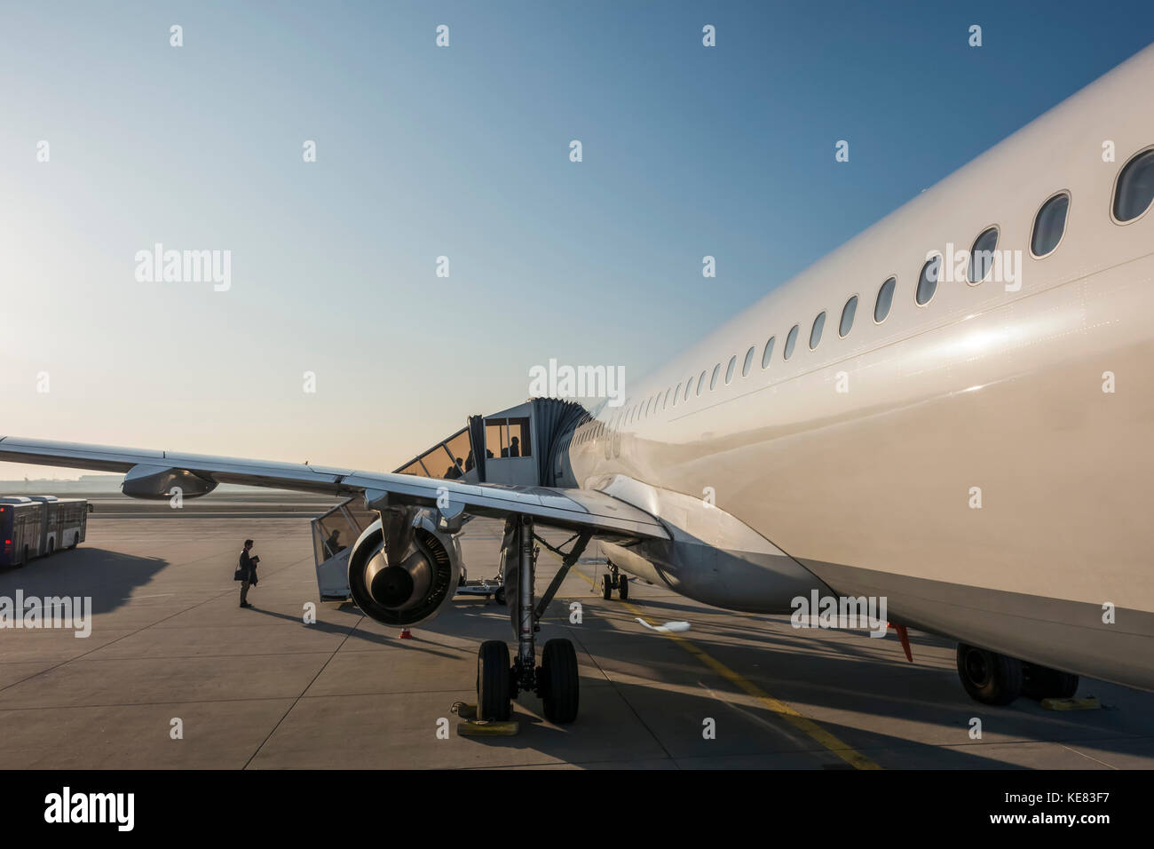 An Airplane Loading Passengers On The Tarmac At Frankfurt Airport; Frankfurt, Germany Stock Photo