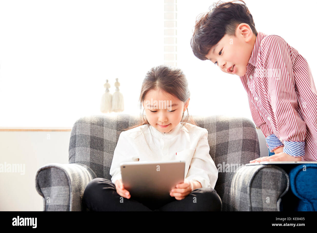 Smiling boy and girl using electric tablets Stock Photo Alamy