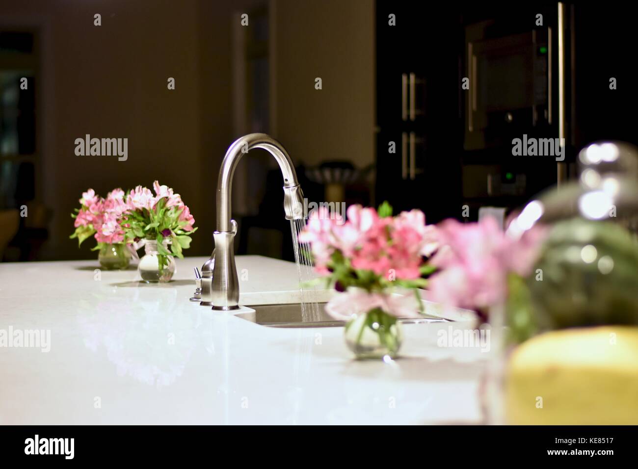 Modern kitchen with flowers on the island Stock Photo Alamy