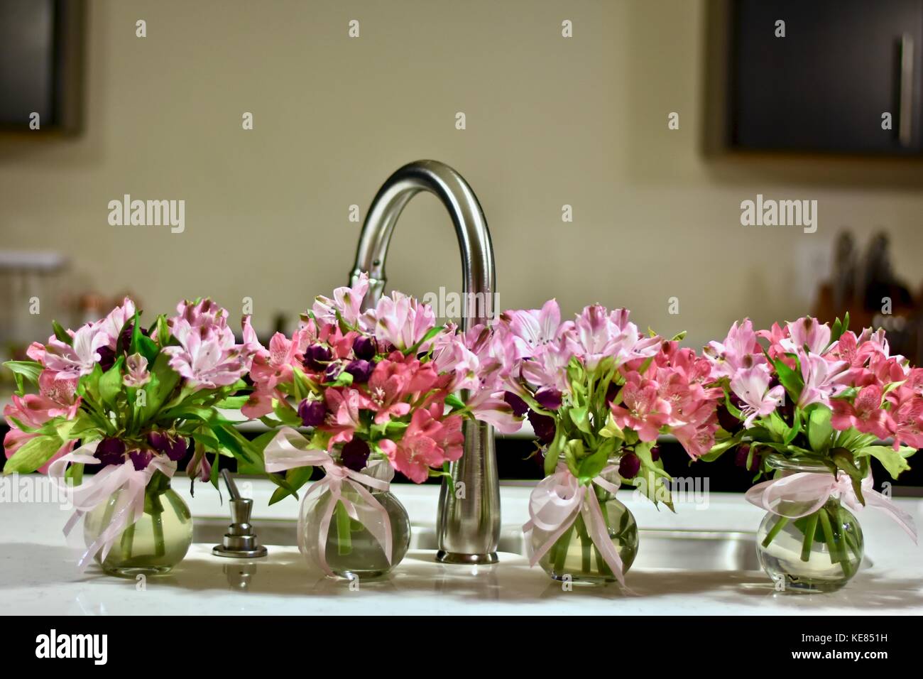 Modern kitchen with flowers on the island Stock Photo Alamy