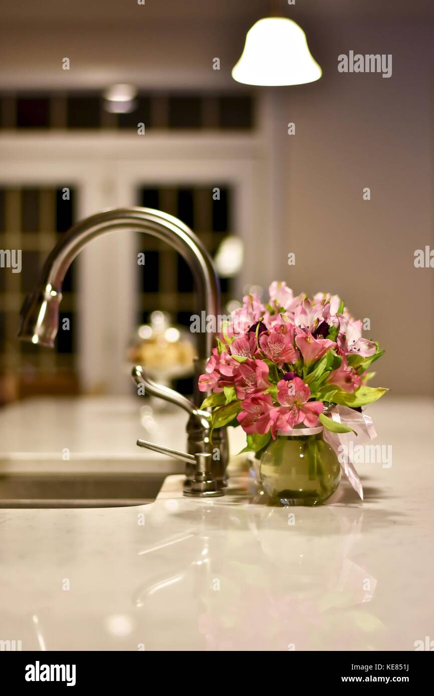 Modern kitchen with flowers on the island Stock Photo Alamy