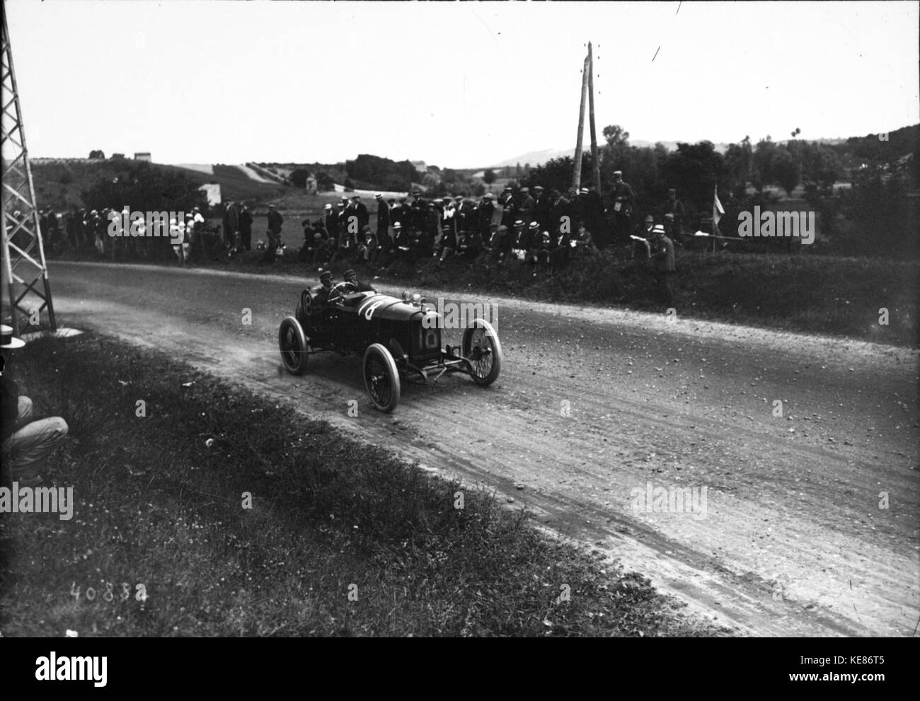 This historical photograph shows Ralph DePalma during the 1914 French Grand Prix, a key event in early motorsport history. DePalma, an American race car driver, was known for his competitive spirit in early 20th-century racing events. Stock Photo
