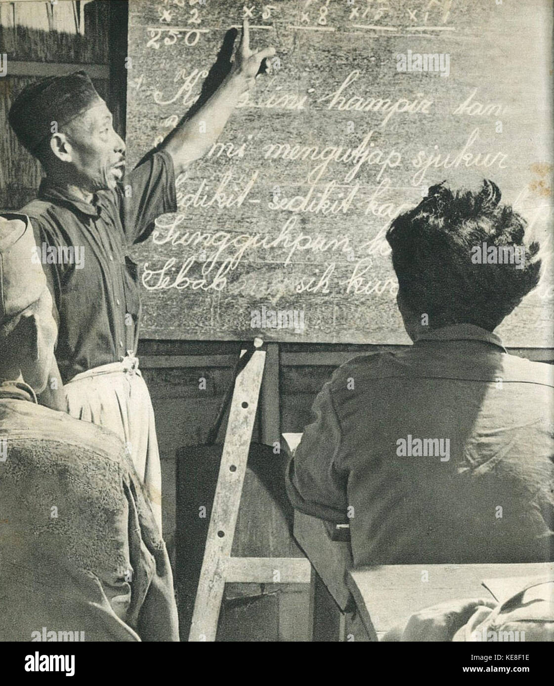 Man teaching adults to read in kalimantan indonesia tanah airku p22