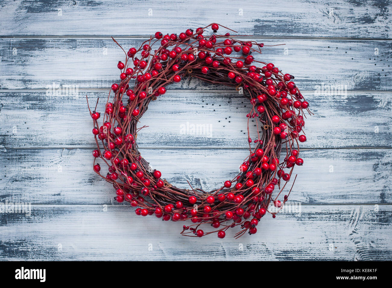Christmas wreath with red berries on the wooden background Stock Photo ...