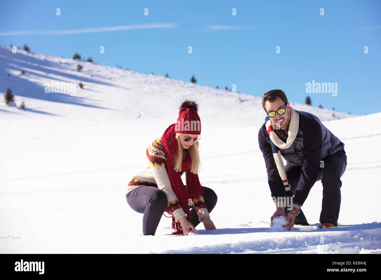 Carefree happy young couple having fun together in snow Stock Photo - Alamy
