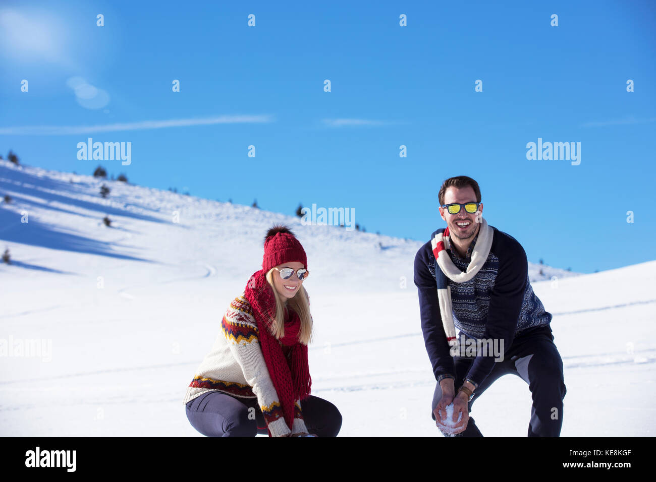 Carefree happy young couple having fun together in snow Stock Photo - Alamy