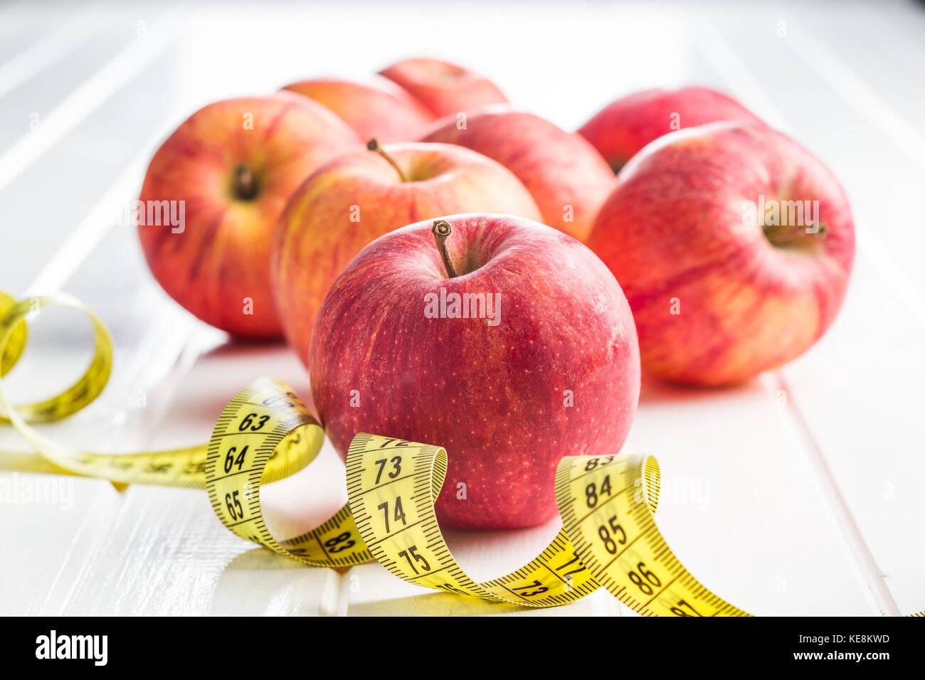 Red apple and measuring tape. Diet concept. Stock Photo