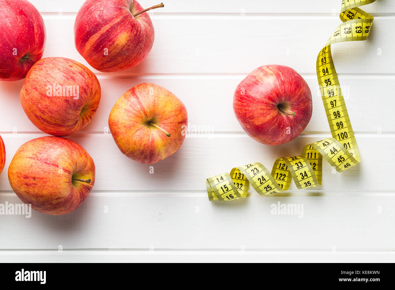Red apple and measuring tape. Diet concept. Stock Photo