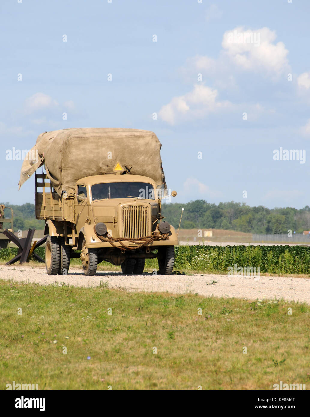 World War II era army truck on a dusty road Stock Photo