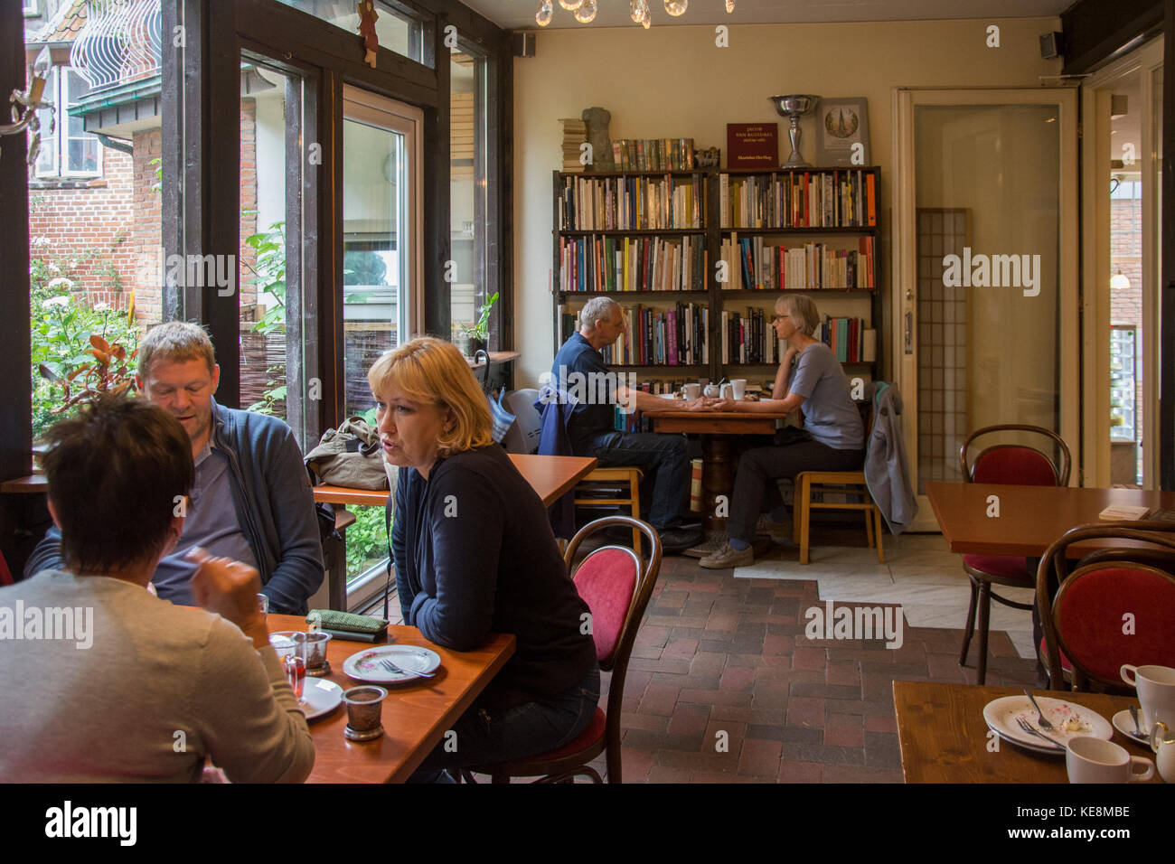 A bookstore cafe provides a cosy and convivial rainy day retreat in Eutin, Holstein, Germany Stock Photo