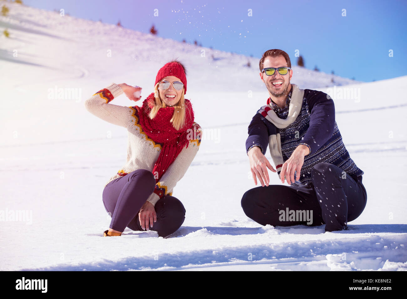 Carefree happy young couple having fun together in snow Stock Photo - Alamy