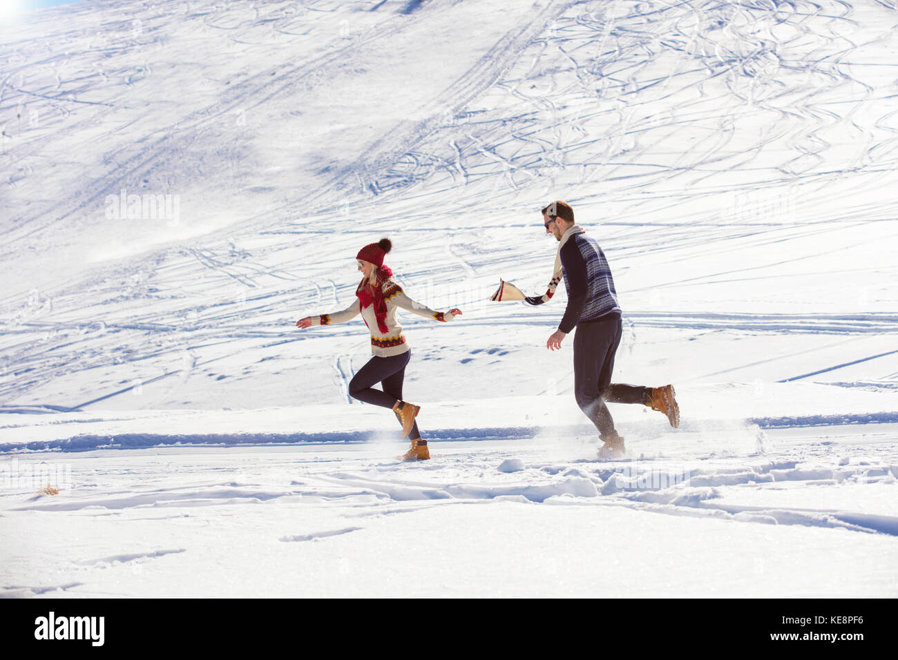Carefree happy young couple having fun together in snow Stock Photo - Alamy