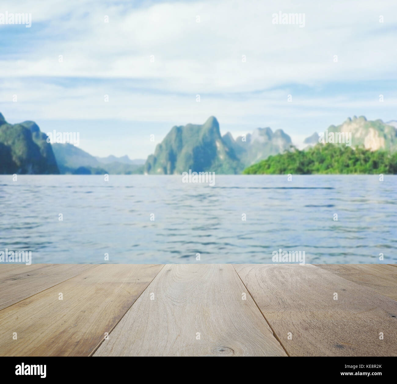 wood table top on blurred beautiful landscape with mountain and lake ...