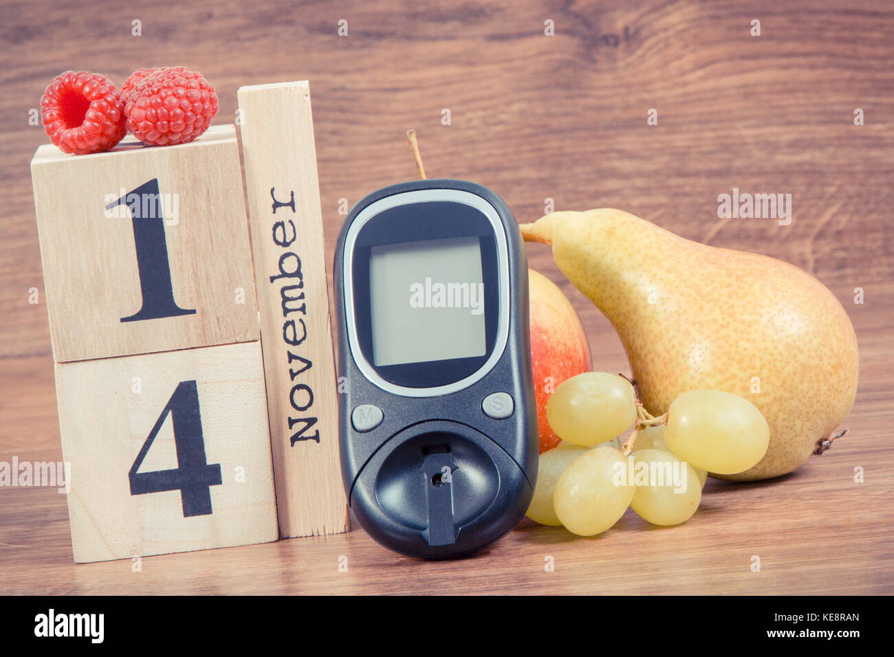 Date of 14 November on cube calendar, and fresh fruits