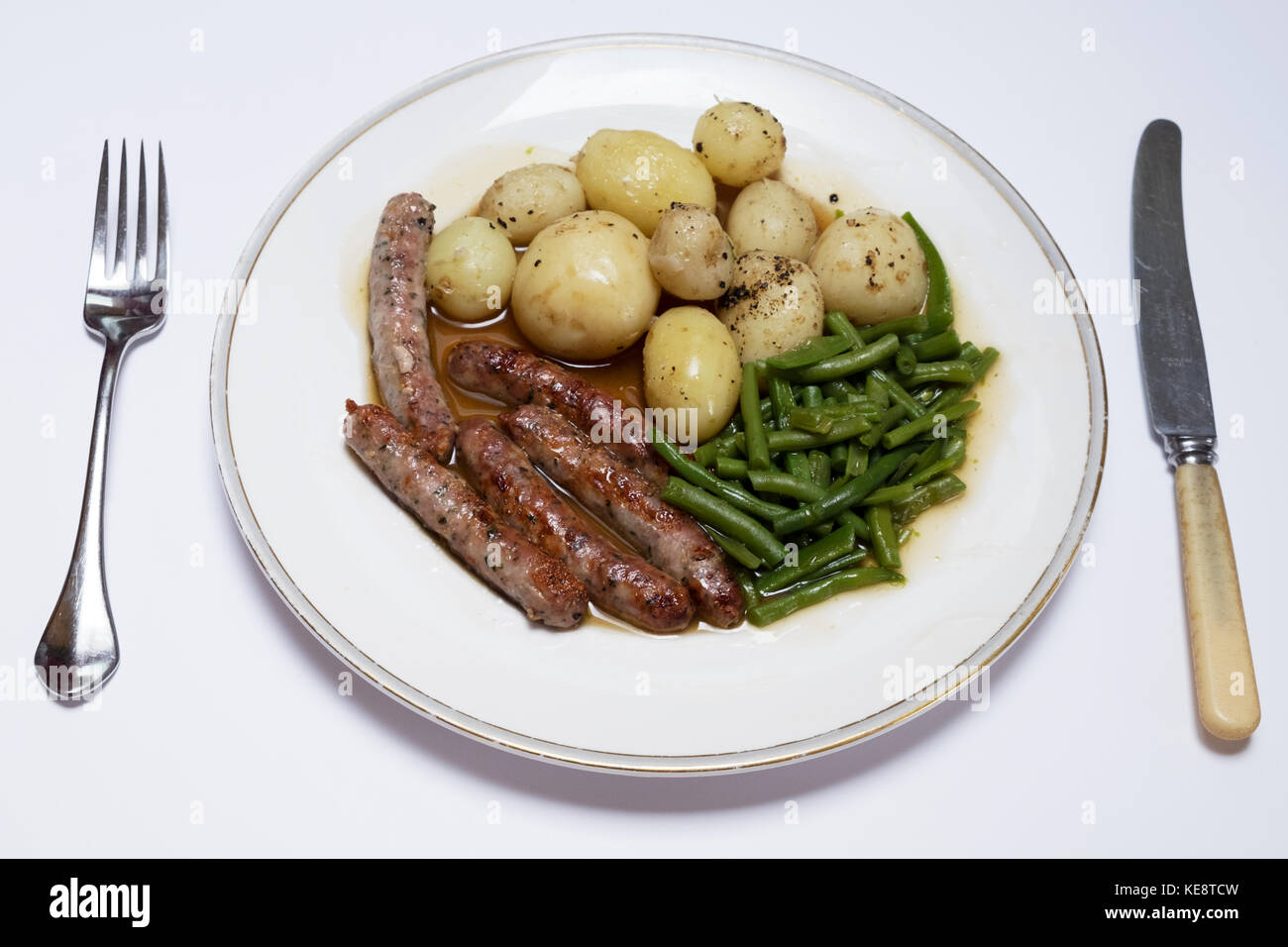 Chipolata sausages, garden new potatoes and French runner beans Stock Photo Alamy