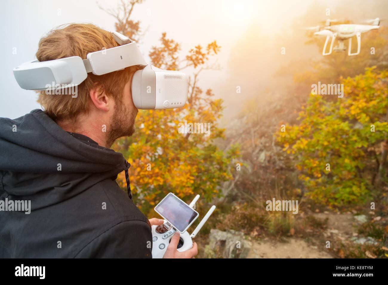 Young man handling drone, using virtual reality glasses. New technology