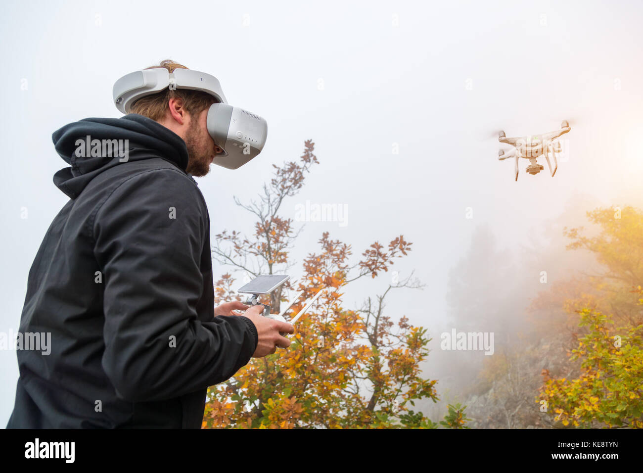 Young man handling drone, using virtual reality glasses. New technology