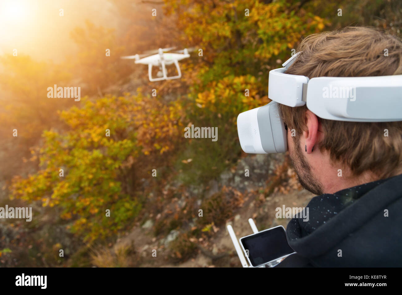 Young man handling drone, using virtual reality glasses. New technology