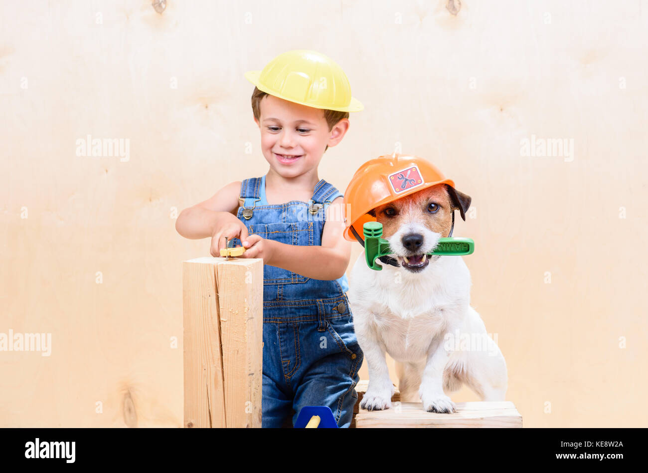 Kid and his pet at construction site working as builders Stock Photo