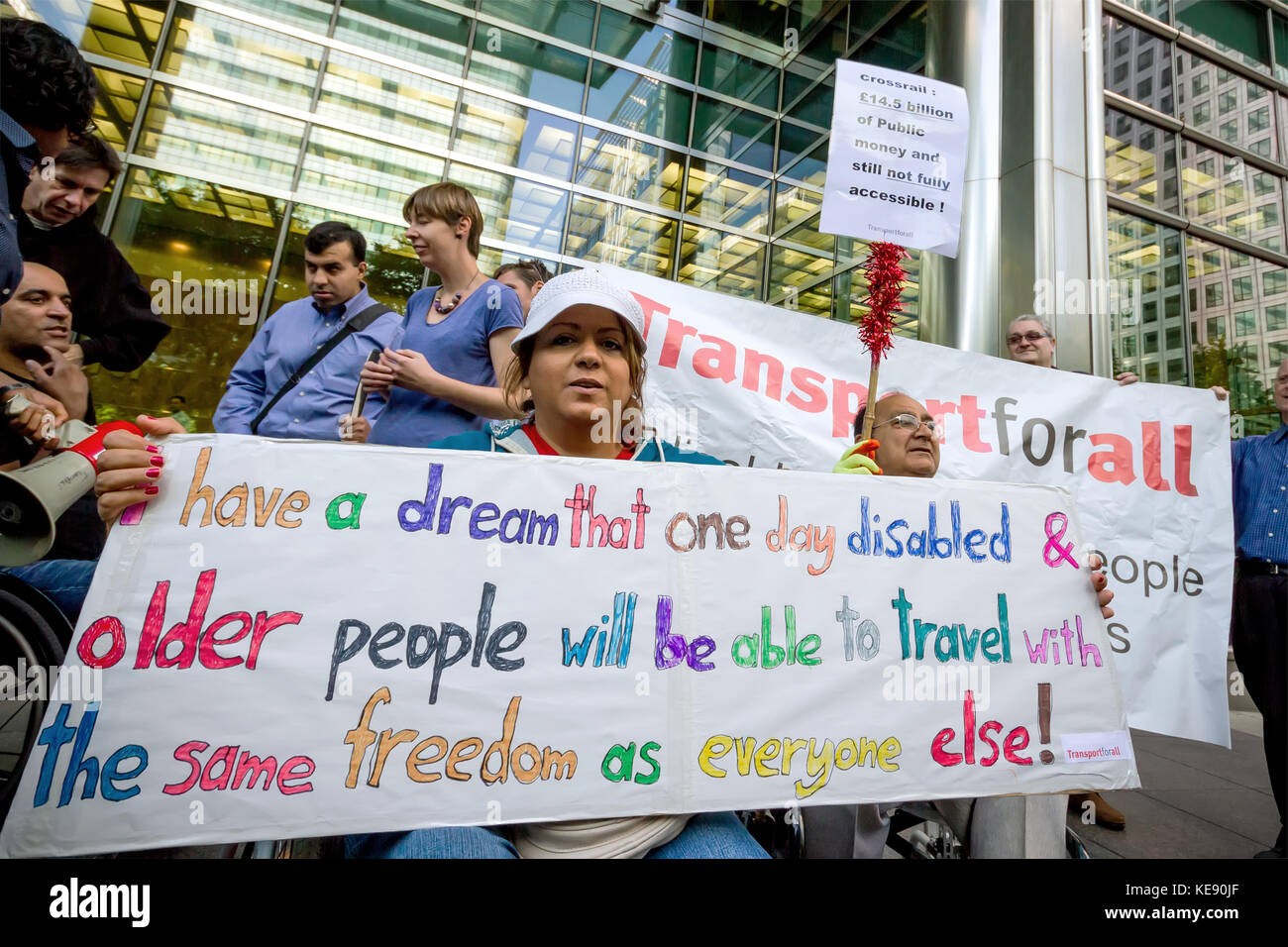 Disability campaigners protest outside the Crossrail head office building in Canary Wharf, London, UK. Stock Photo