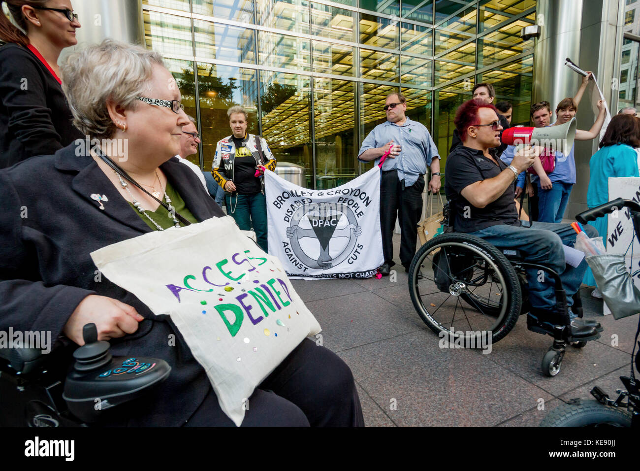 Disability campaigners protest outside the Crossrail head office building in Canary Wharf, London, UK. Stock Photo
