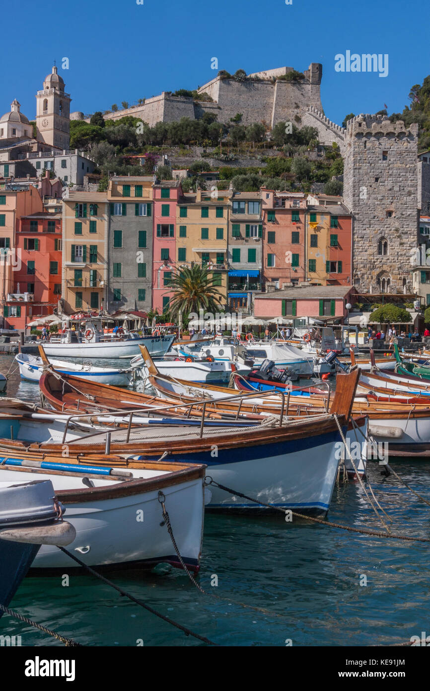 The harbour at Portovenere, on the coast of Liguria, North West Italy. Doria Castle is on the background, behind rows of colourful terraced houses Stock Photo
