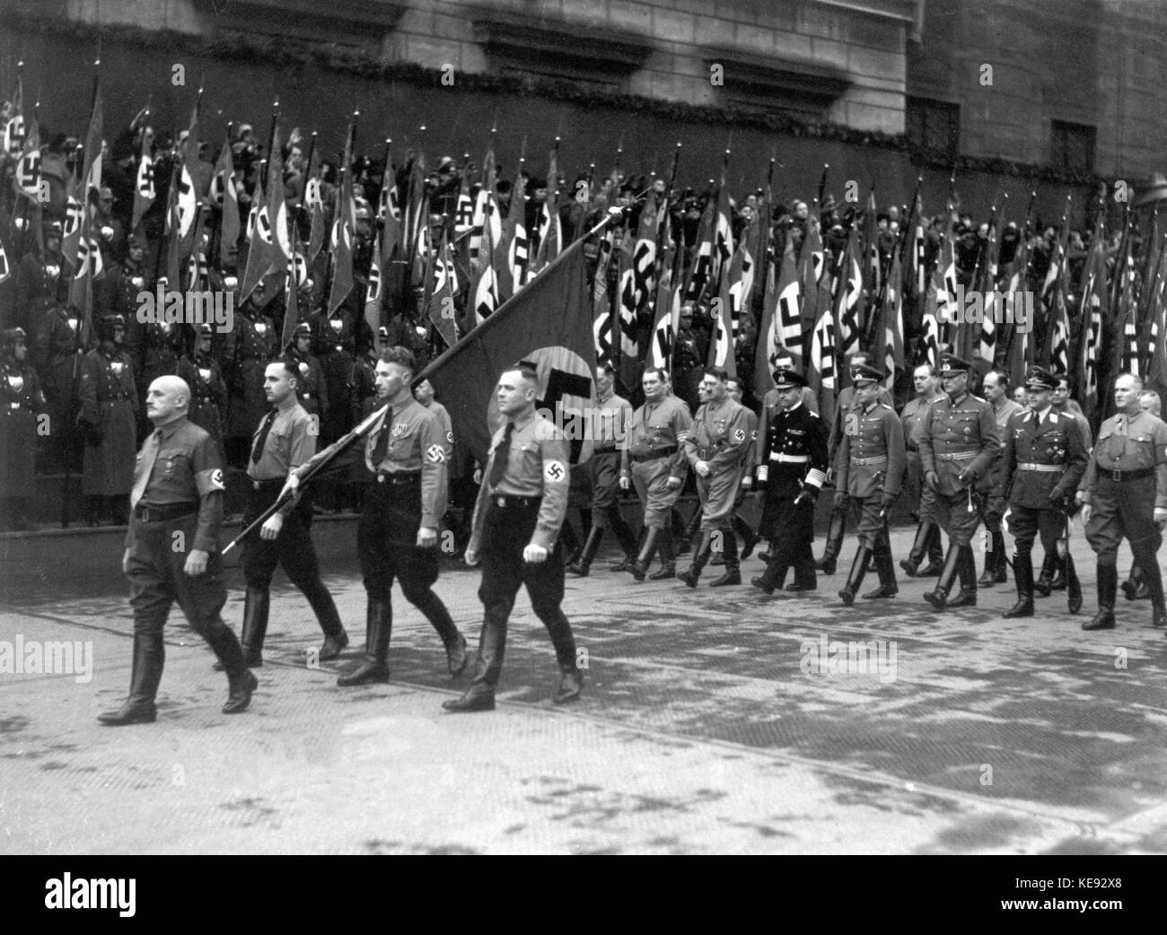 March on 9 November 1938 through Munich in memory of the failed Beer Hall Putsch fifteen years ago. Three party members are marching with the swastika flag behind Julius Streich at the head. Behind them (l-r): Hermann Göring, Adolf Hitler, Erich Raeder, Walter von Brauchnitsch, Wilhelm Keitel, and Erhard Milch. | usage worldwide Stock Photo