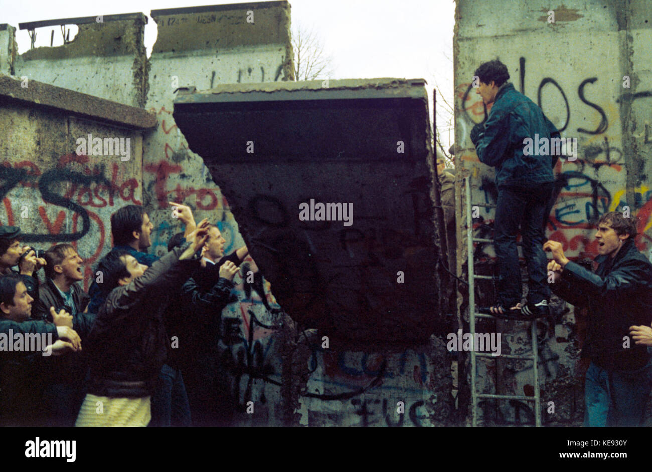 Citizens are supporting the demolition of the Berlin Wall at the German-German borderline on 11 November 1989 (Berlin, Germany). Germany reunited on the night of 9/10 November 1989. The GDR joined the Federal Republic of Germany on 3 October 1990.    | usage worldwide Stock Photo