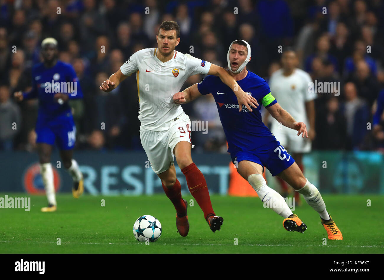 Roma's Edin Dzeko (left) and Chelsea's Gary Cahill battle for the ball during the UEFA Champions League, Group C match at Stamford Bridge, London. Stock Photo