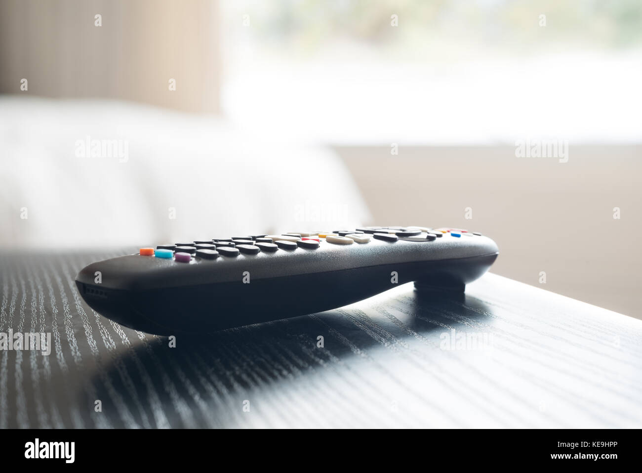 Close up of the remote control of a smart TV in the night table of a bedroom Stock Photo