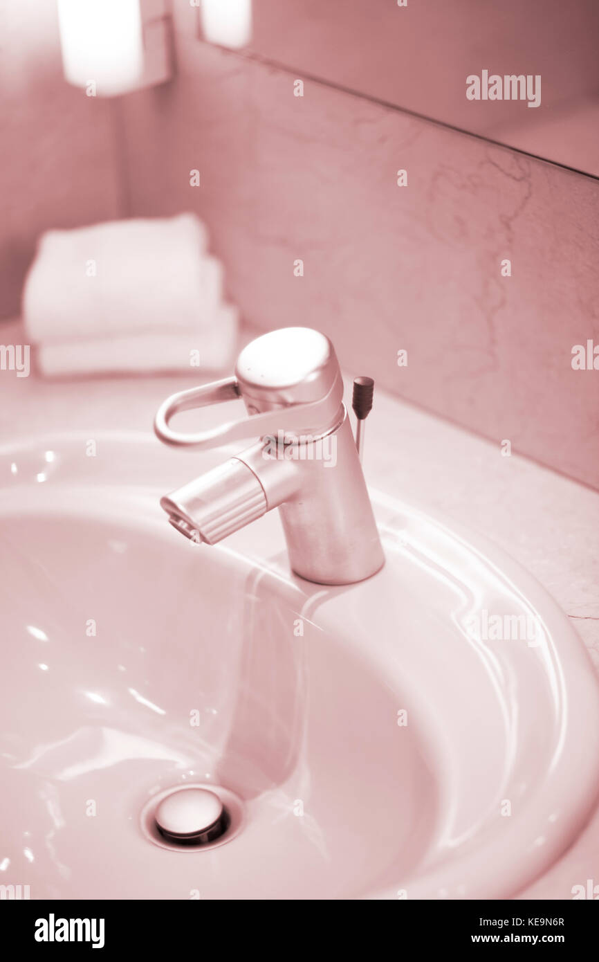 Luxury hotel bathroom sink tap cleaned and ready for guests to use ...