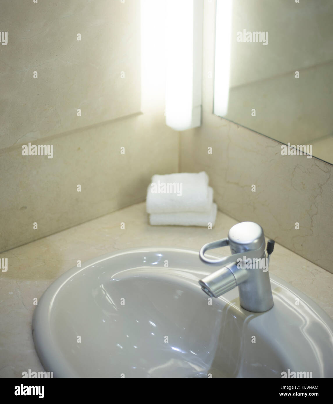 Luxury hotel bathroom sink tap cleaned and ready for guests to use