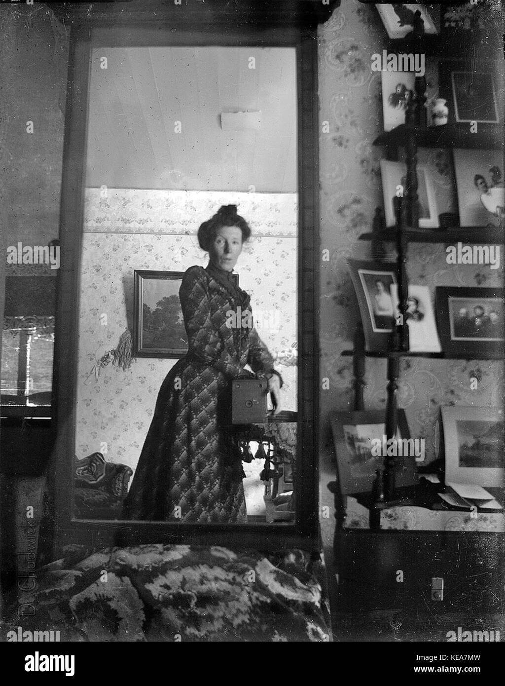 Unidentified woman taking her own photograph using a mirror and a box camera, roughly 1900 Stock Photo