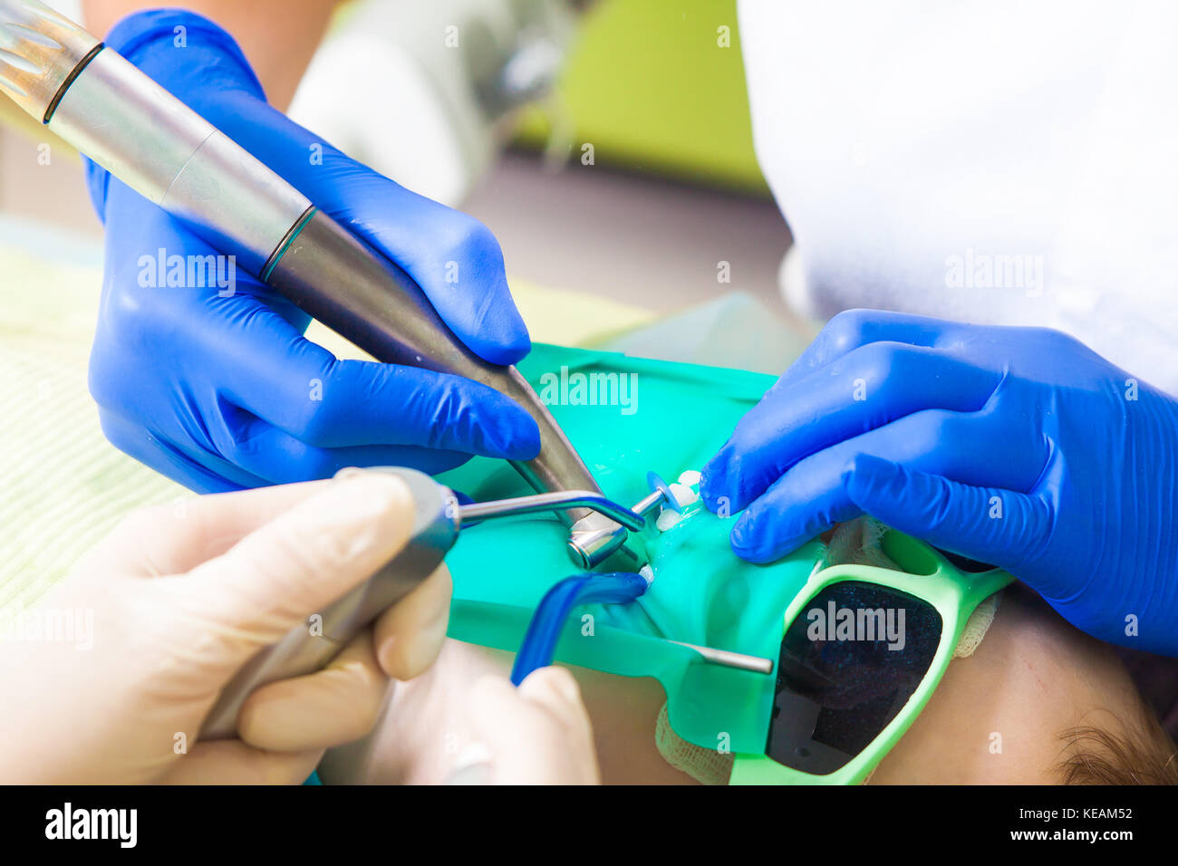 Closeup of a female dentist in medical uniform and sterile gloves and
