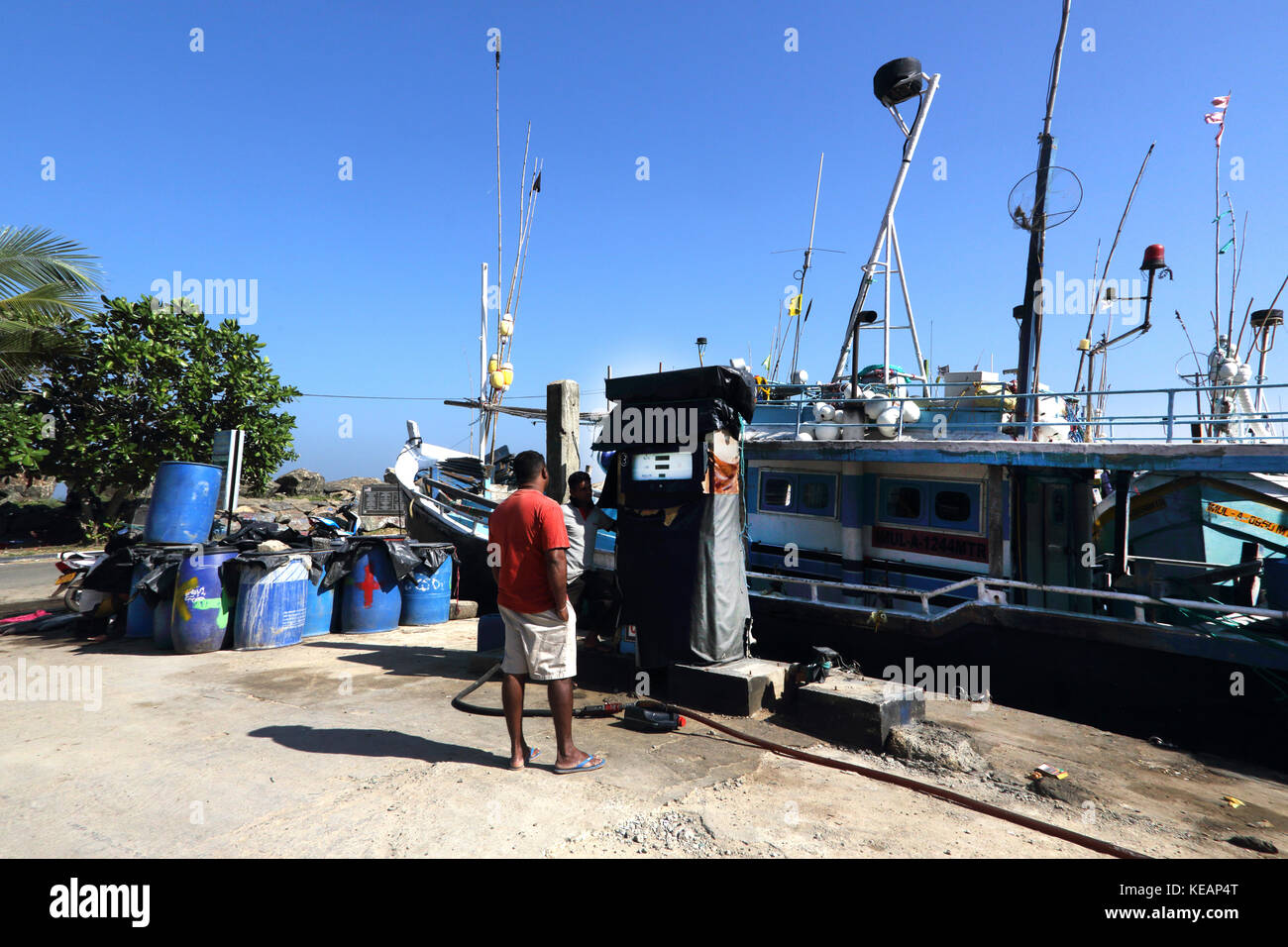 Mirissa Fishery Harbour Southern Province Sri Lanka Men Refuelling Fishing boat Stock Photo