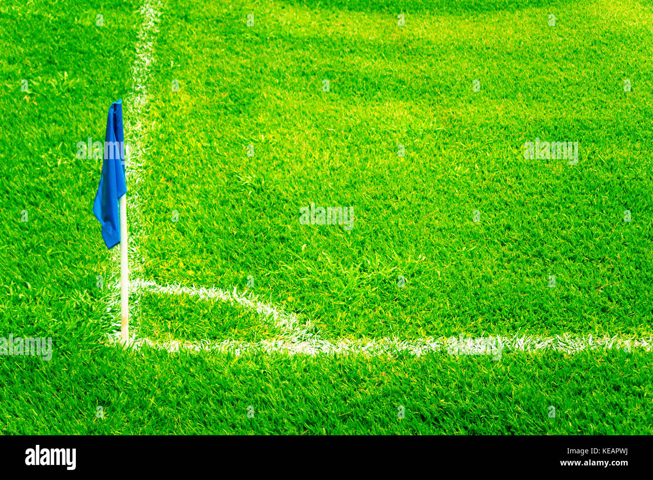 Blue Corner Flag on a Football Field with Bright Fresh Green Turf Grass