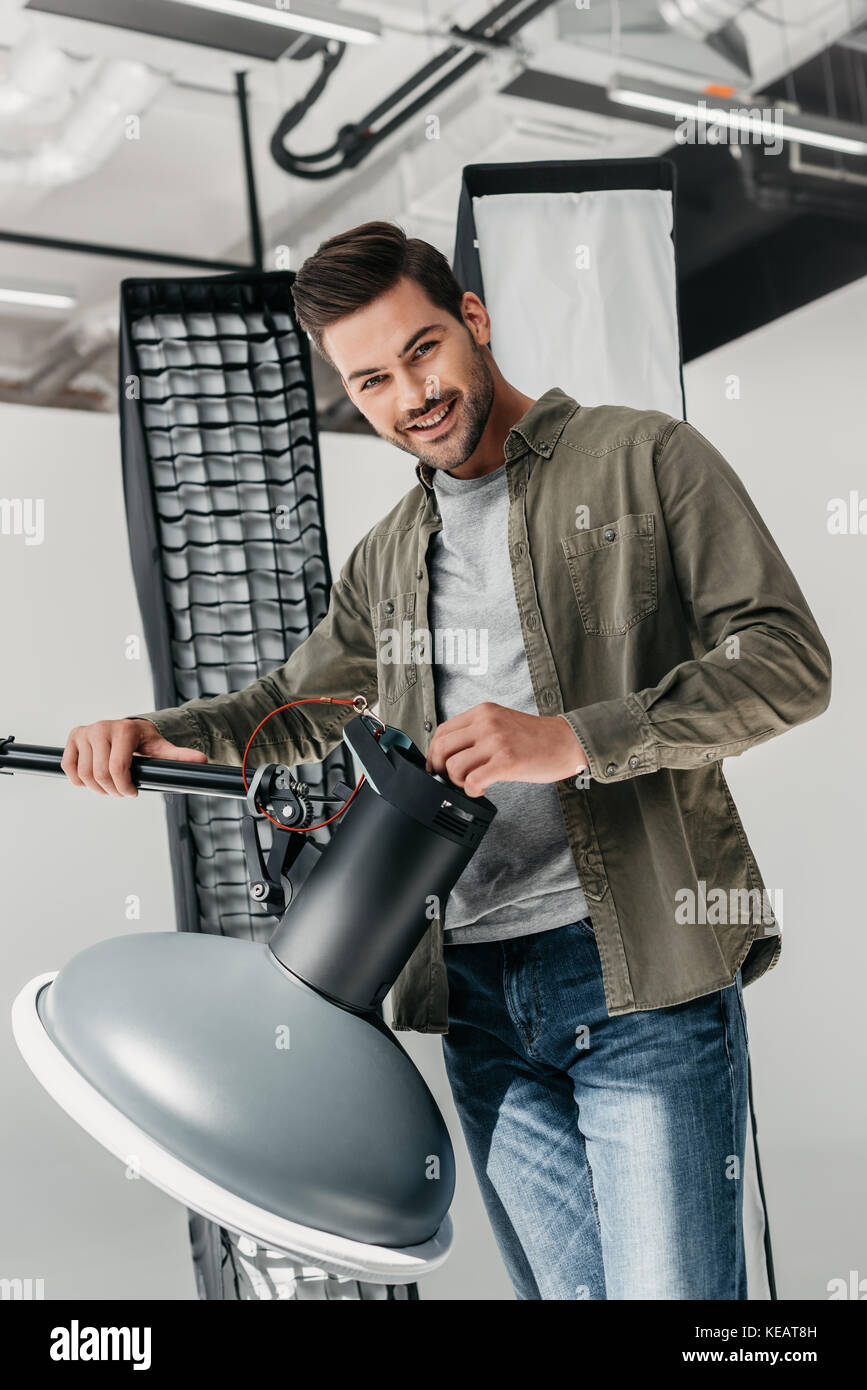 photographer with lighting equipment in studio Stock Photo Alamy