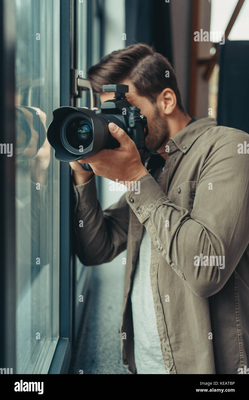 photographer with camera at window Stock Photo