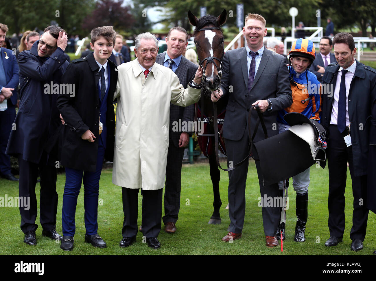 Trainer Aidan O'Brien (left) owner Derrick Smith (centre) and Jockey Ryan Moore (second right) after winning The Kingdom Of Bahrain Sun Chariot Stakes on Roly Poly at Newmarket Racecourse Stock Photo