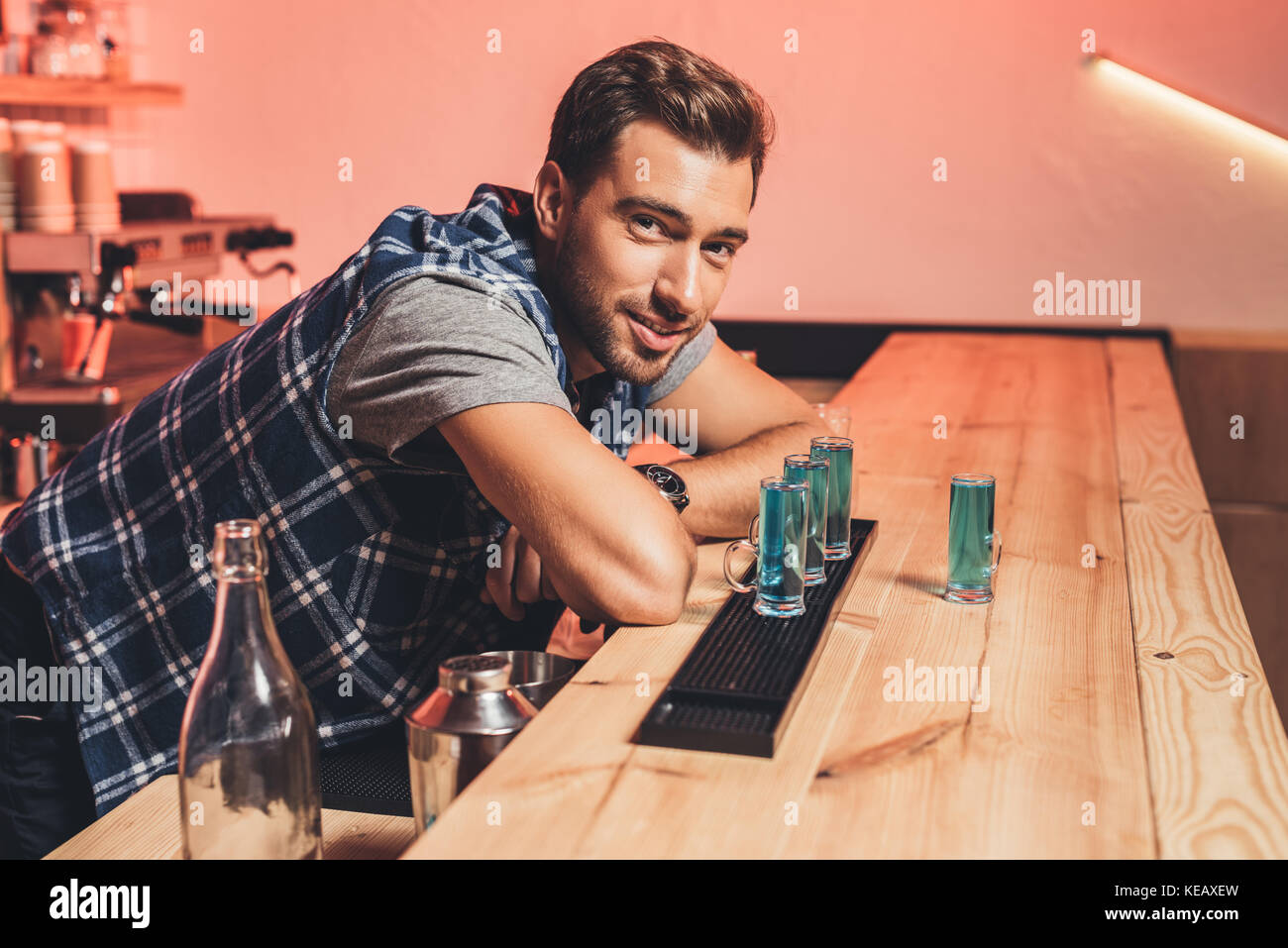 barman with alcohol shots on counter Stock Photo