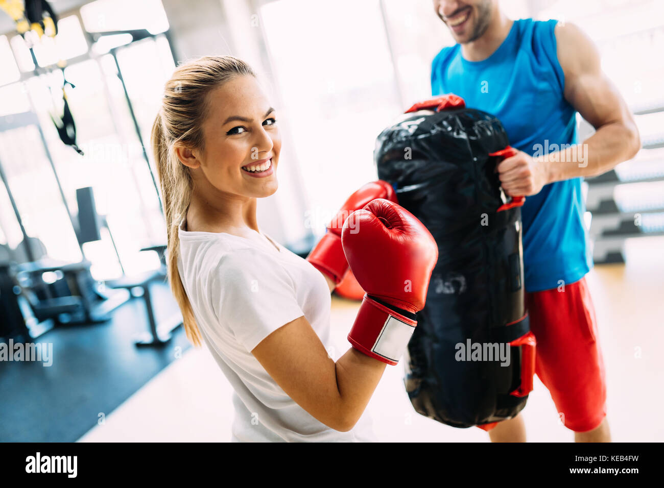 Picture of woman wearing boxing gloves in gym Stock Photo
