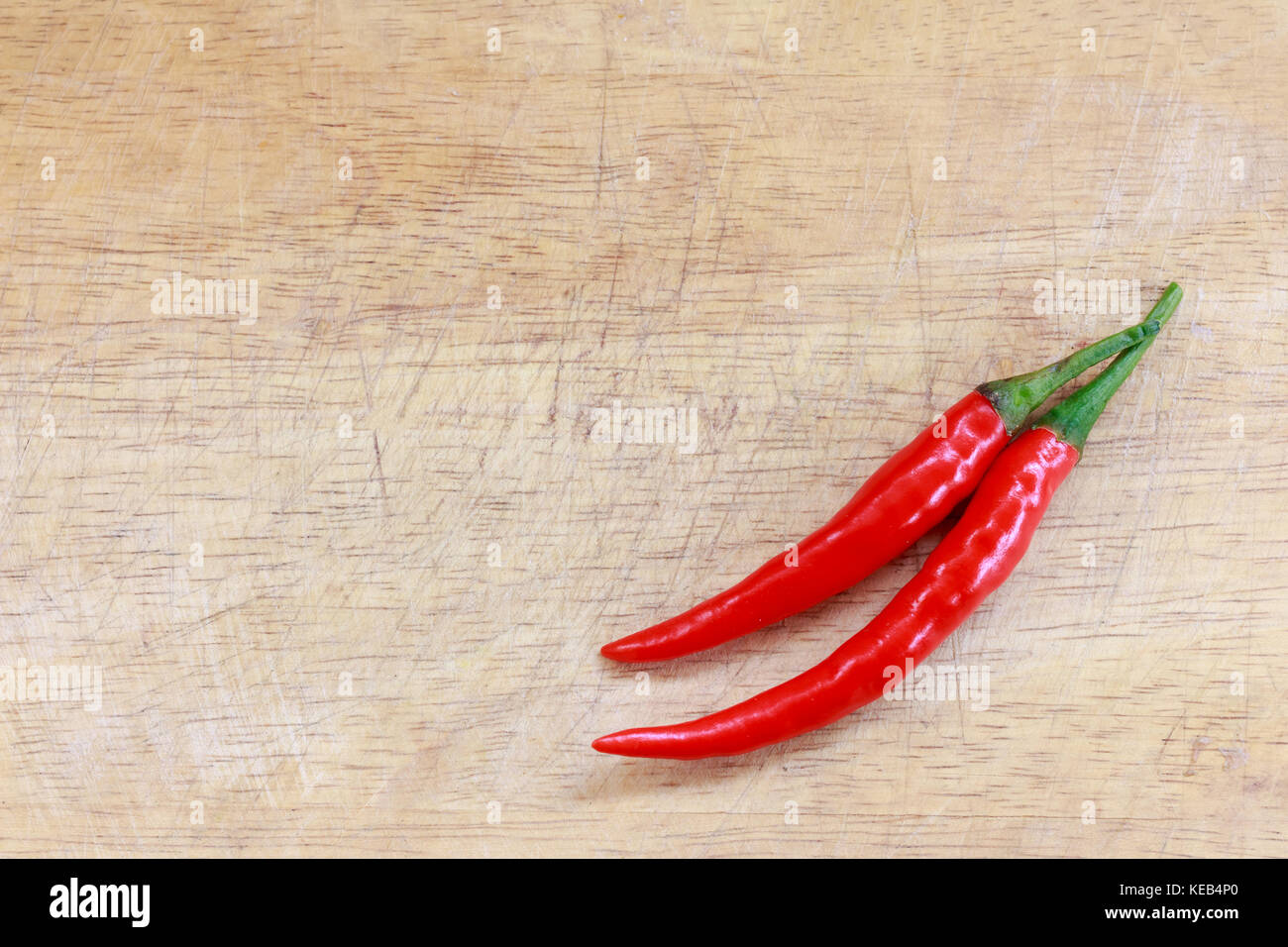 red hot chili peppers on the wooden background Stock Photo - Alamy