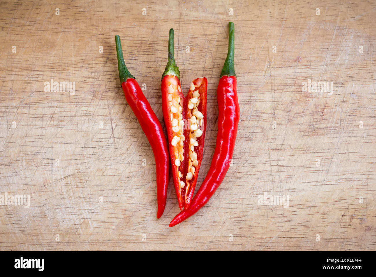 red hot chili peppers on the wooden background Stock Photo - Alamy