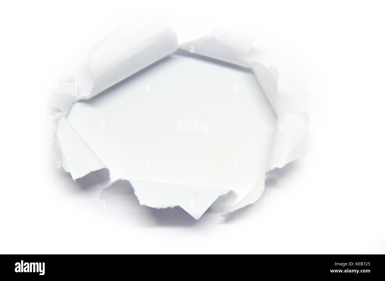 Hole in the paper with torn side, isolated Stock Photo Alamy