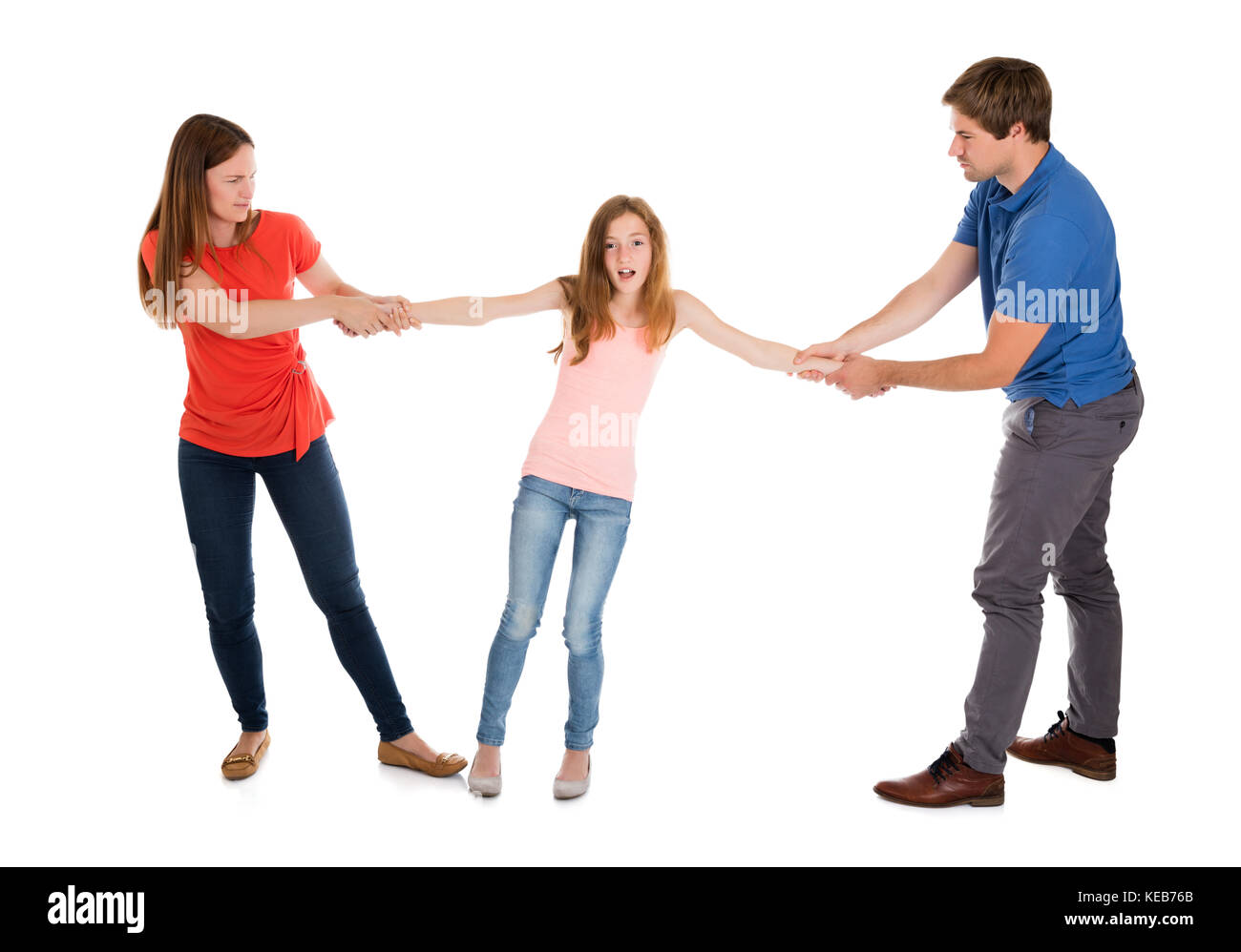 Unhappy Couple Pulling Their Daughter On Their Side On White Background Stock Photo