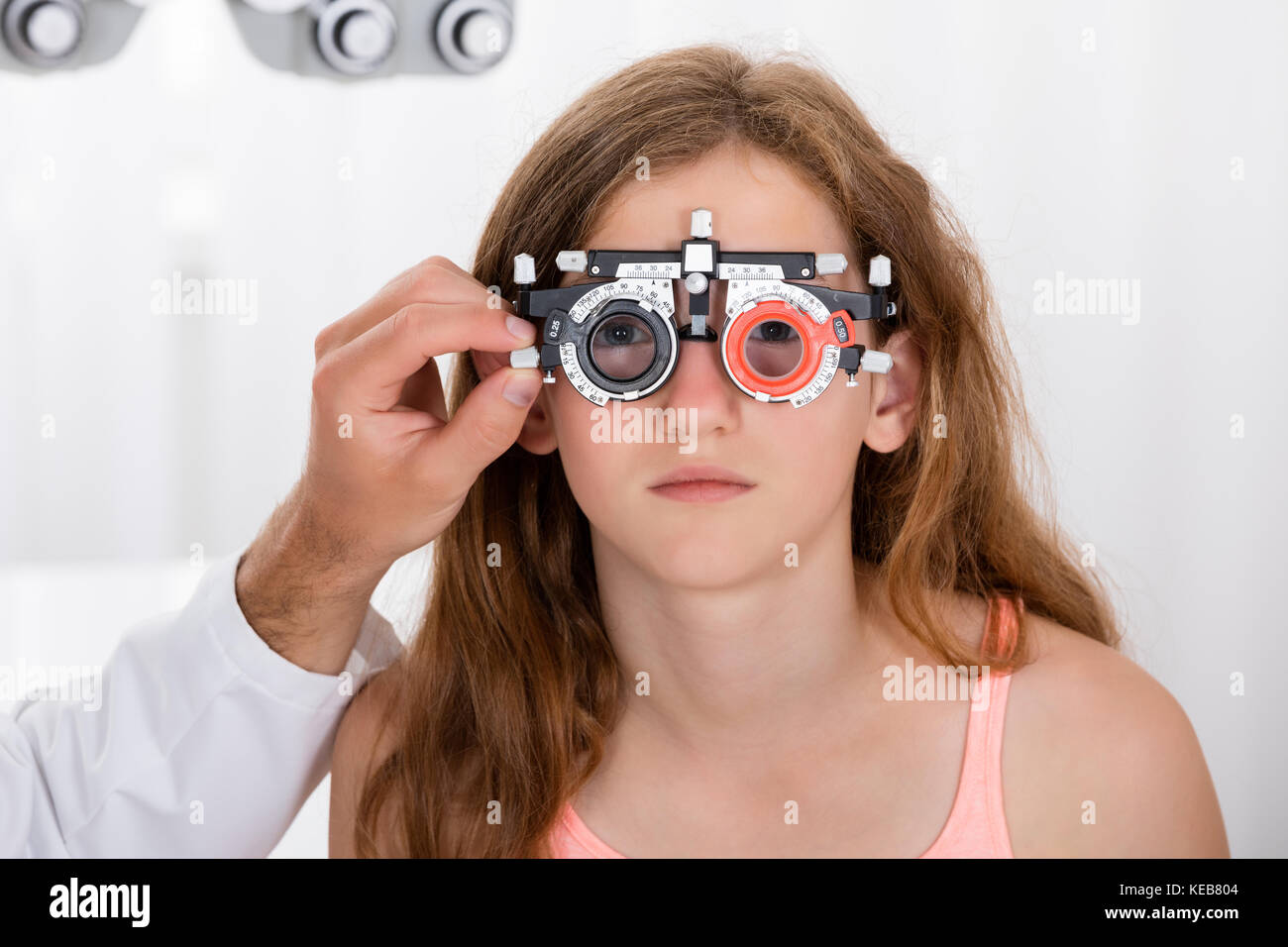 Close-up Of An Optometrist Checking Girl's Vision With Trial Frame At Eye Clinic Stock Photo