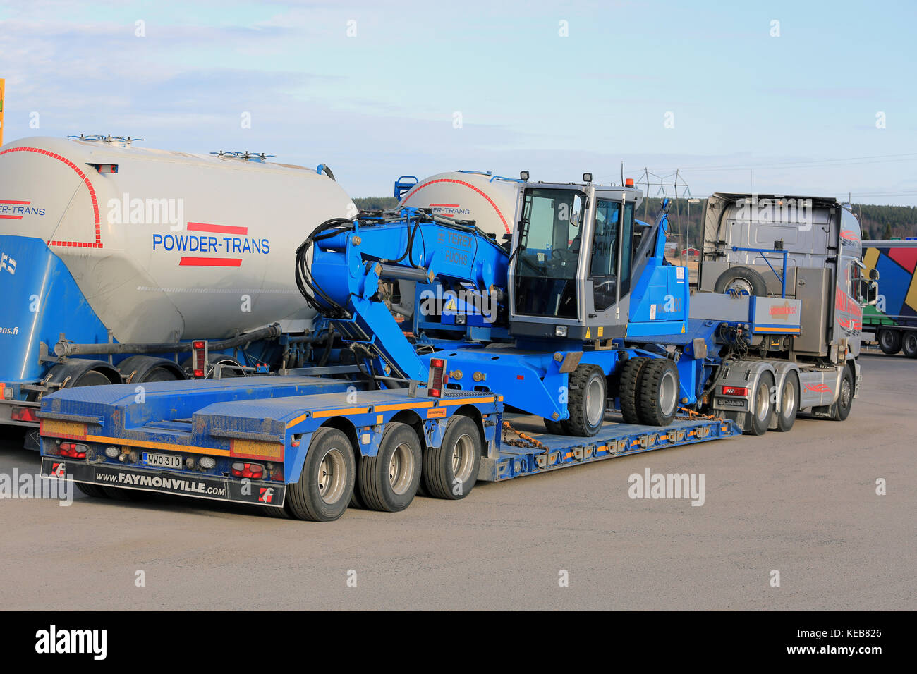 SALO, FINLAND - APRIL 15, 2016:  Terex Fuchs MHL 320 material handler on Scania semi trailer, parked on truck stop, back and side view. Stock Photo