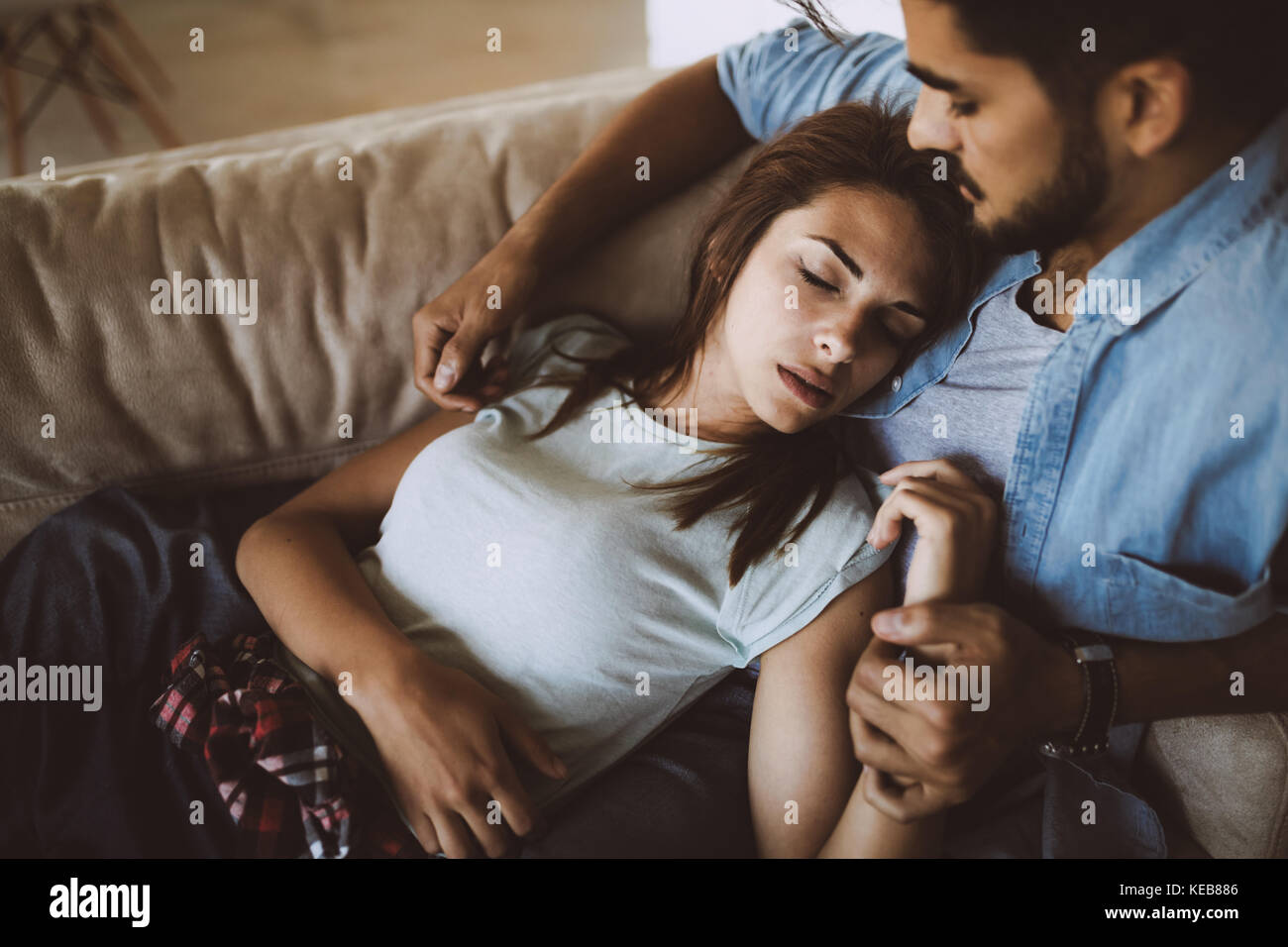 Pretty young girl lying on lap of her boyfriend Stock Photo