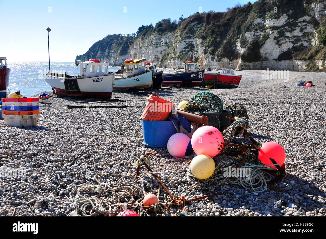 Boats and fishing gear on the beach at Beer in Devon, UK. Stock Photo